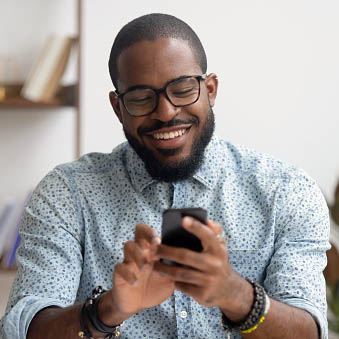 happy man texting on cell phone