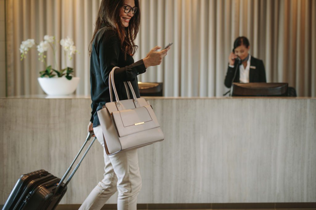 woman using smartphone in hotel lobby