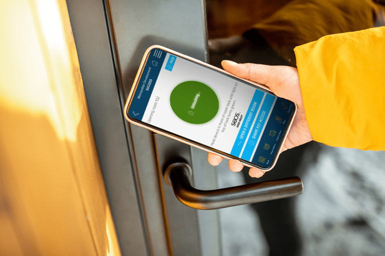 Hotel guest using hotel mobile key to unlock hotel room door.